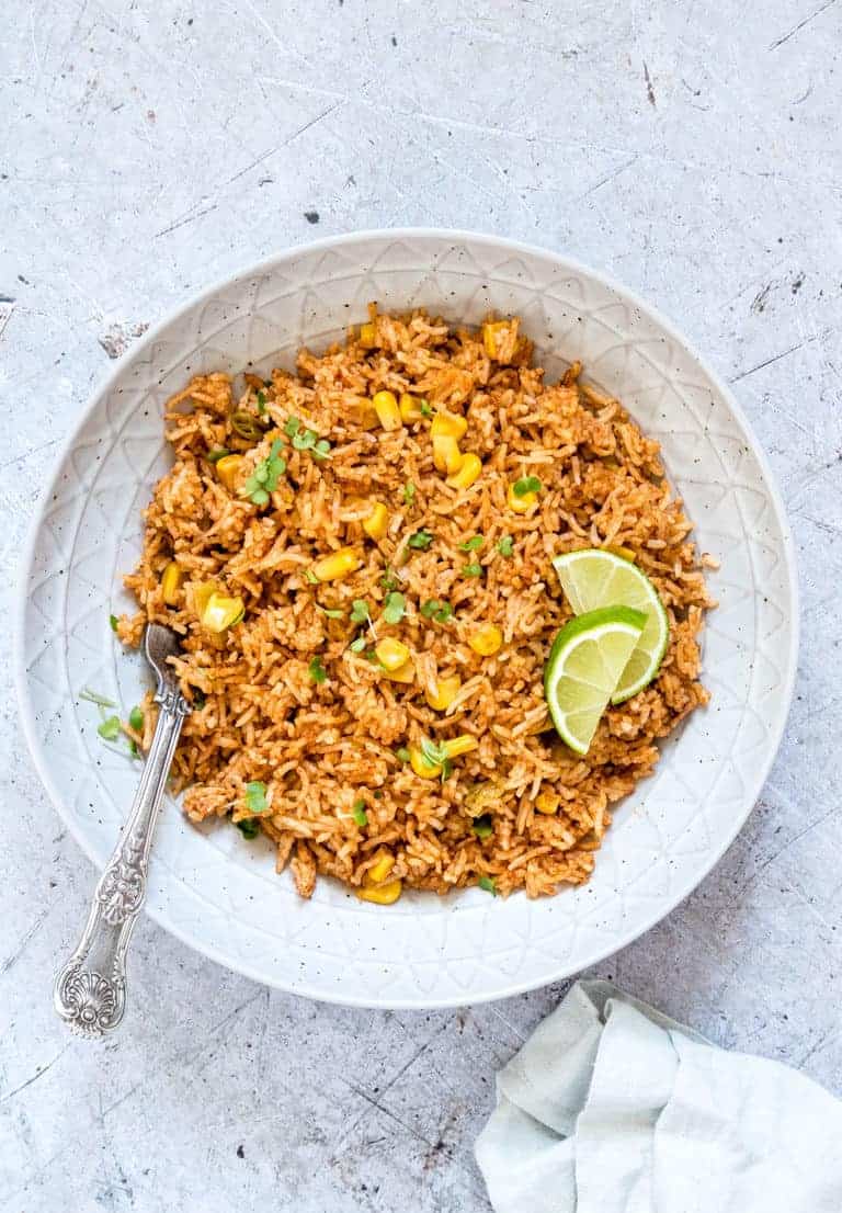 instant pot mexican rice in a bowl with limes on top