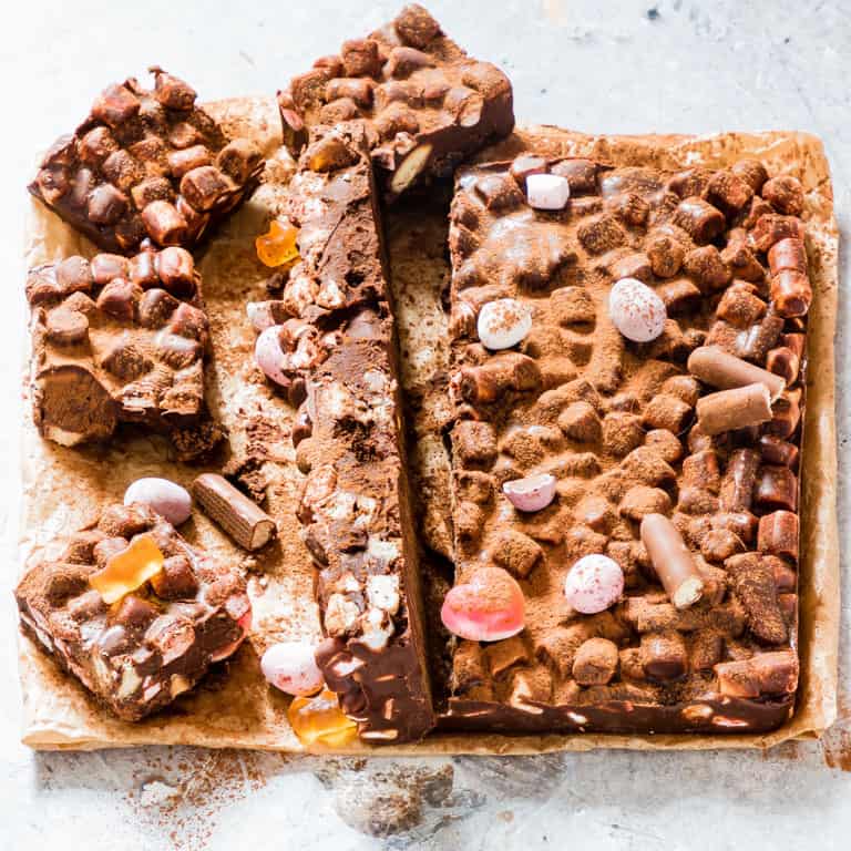 overhead view of rocky road cake containing chocolate and marshmallows cut into pieces