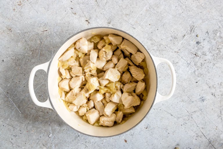 overhead view of chunks of chicken in a pot for white chicken chili