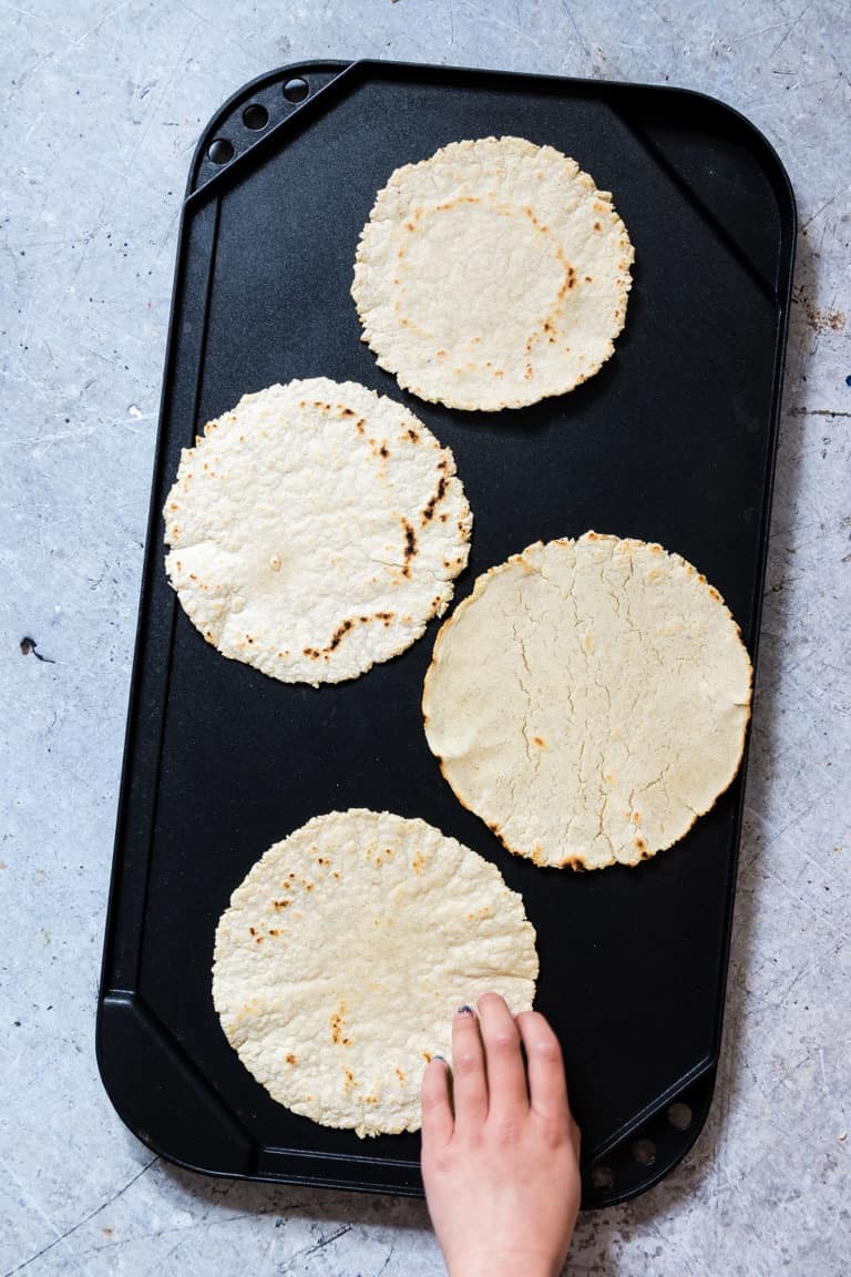 4 Corn Tortillas on a griddle plate