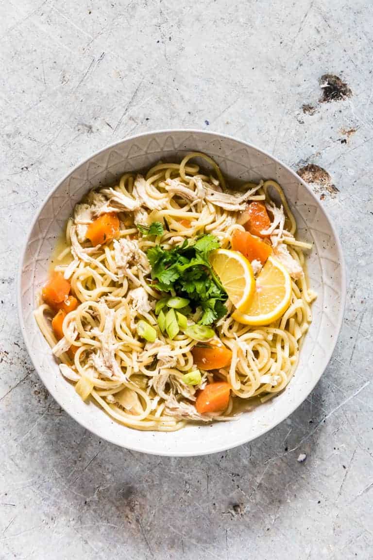 A comforting bowl of instant pot chicken noodle soup with vegetables and garnished