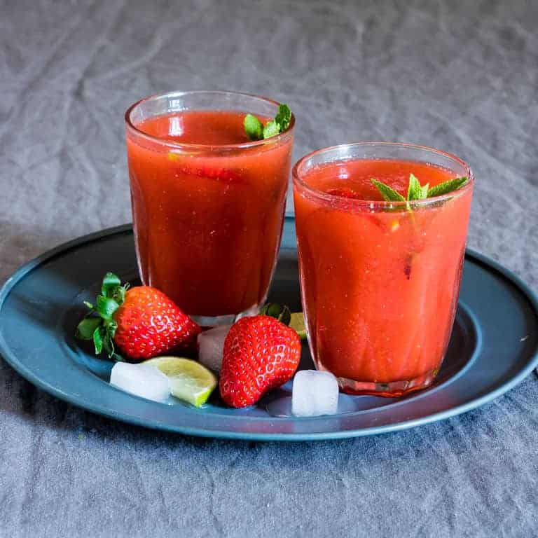 strawberry daiquiri drinks in glasses on a blue platter