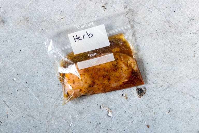 overhead view of herb chicken marinades in ziploc bag