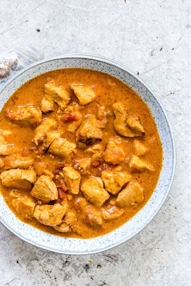 Creamy chicken curry in a bowl on a table