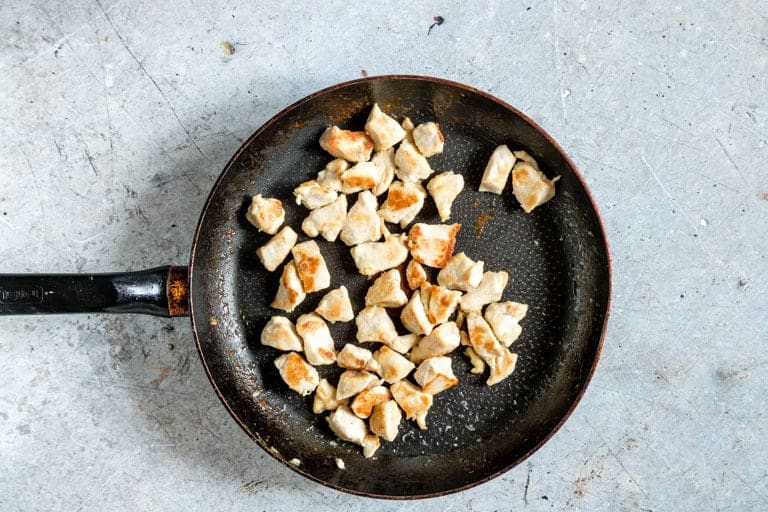 orange chicken pieces cooked on a skillet on countertop
