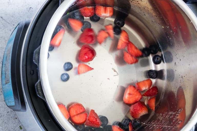 blueberries and strawberries and water in an instant pot