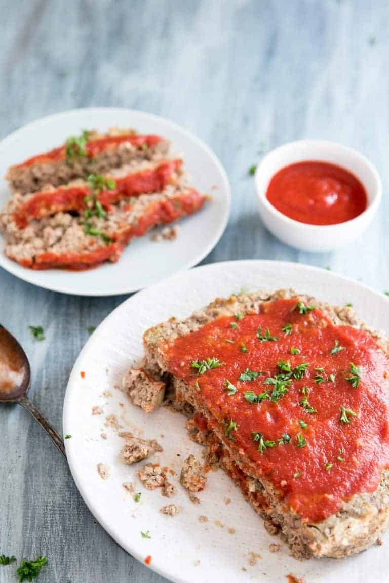 instant pot meat loaf half loaf on a white plate next to served meat loaf on a plate