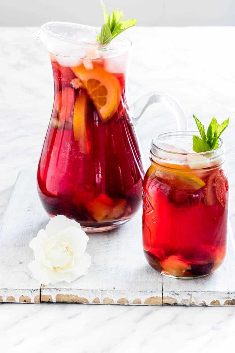 a jug and glass of non alcoholic sangria