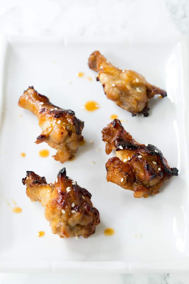 instant pot chicken wings on a white plate with teriyaki sauce