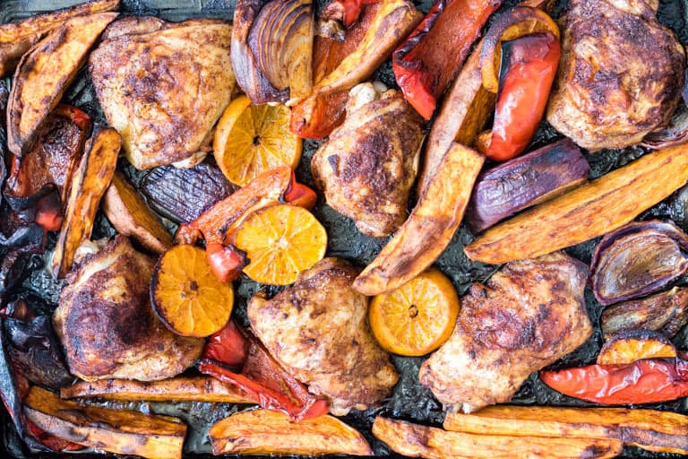 Close up Sheet Pan Chicken Thighs with vegetables on a sheet pan