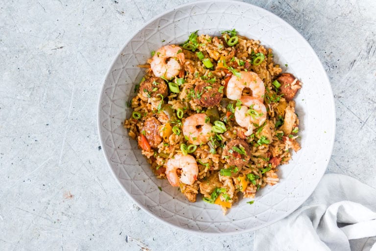 instant pot jambalaya in a white bowl on a light countertop