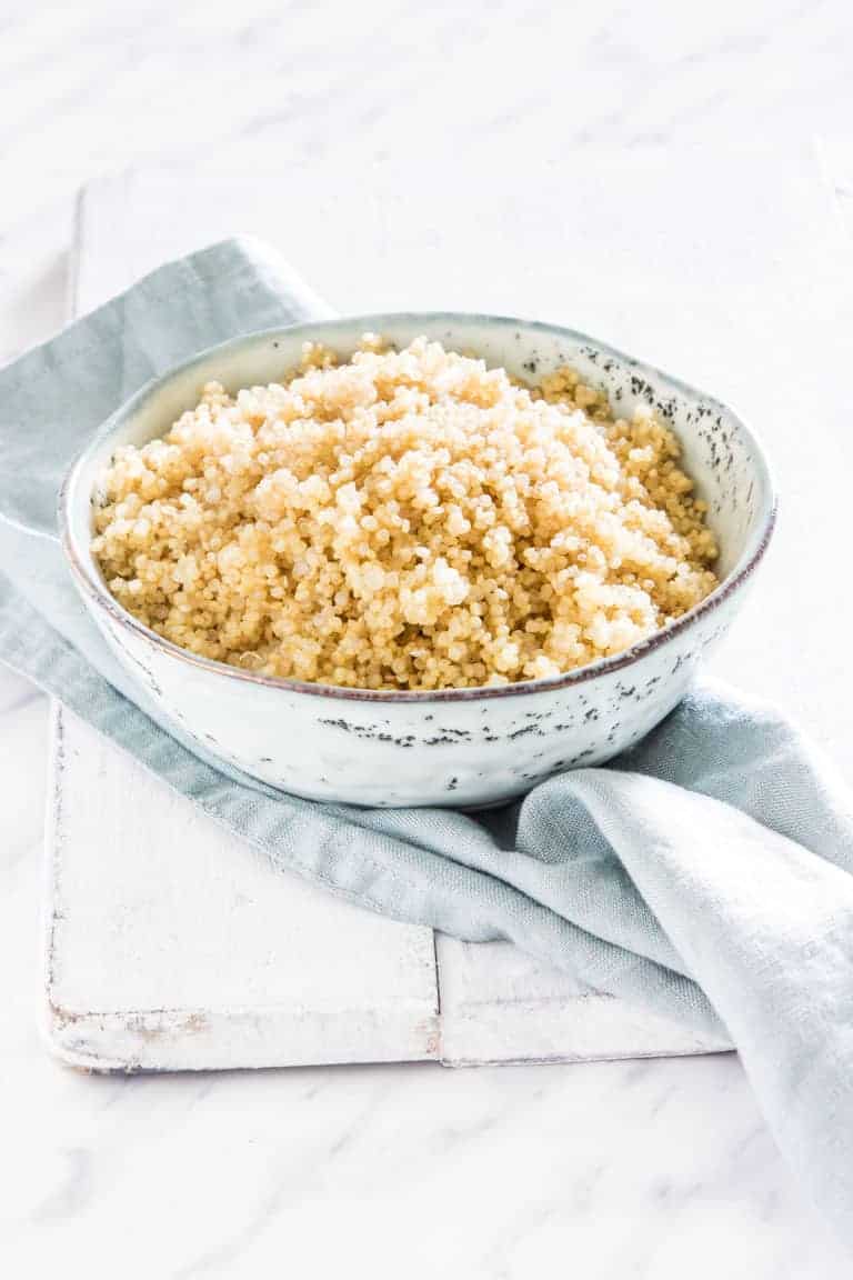 A bowl of cooked pressure cooker quinoa on a table