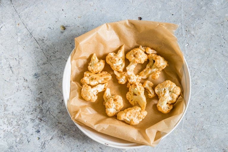 uncooked cauliflower wings in a baking tray