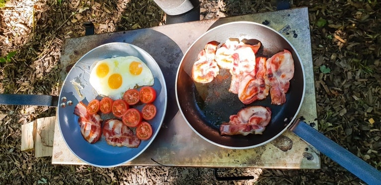 cooking breakfast at Feather Down Farms Glamping UK