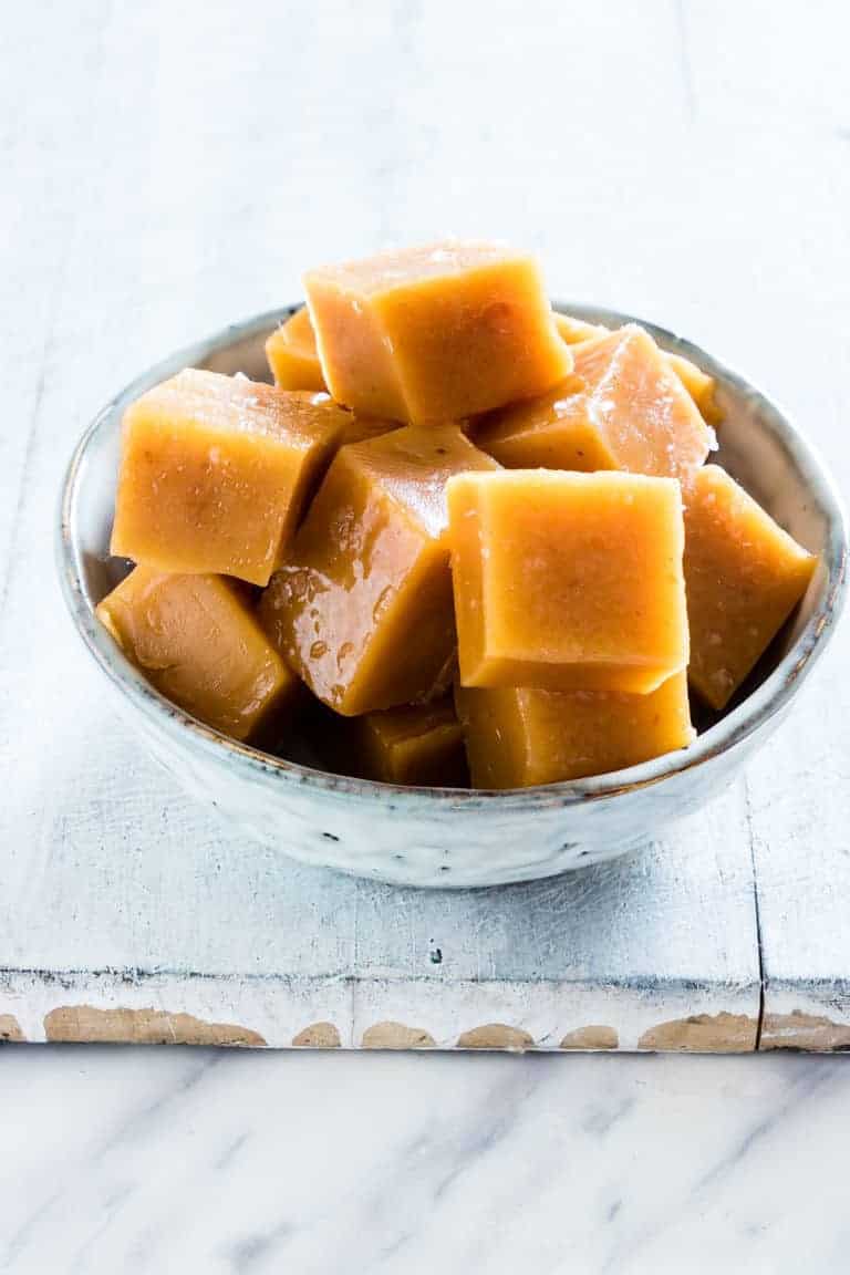 a bowl of salted pumpkin caramels on a table