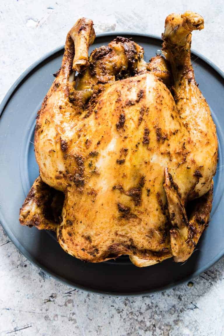 whole chicken in the slow cooker on a plate