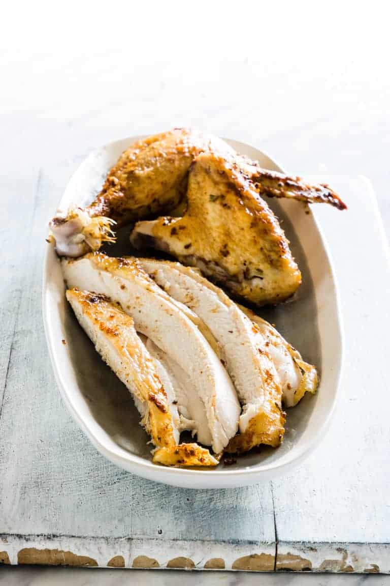 slices of crockpot whole chicken on a plate