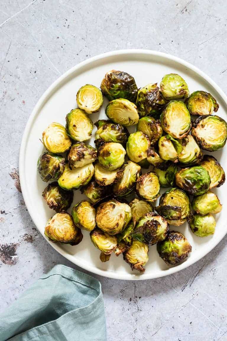 plate full of crispy air fryer brussel sprouts on a table