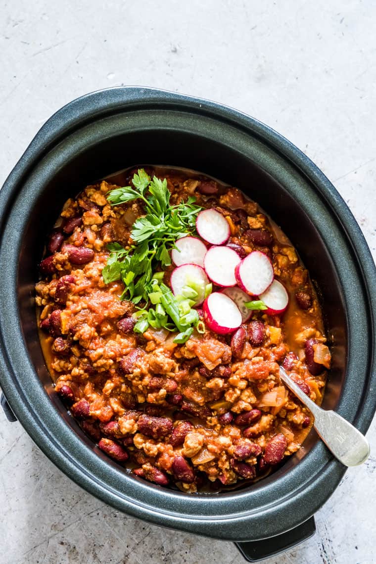 SLOW COOKER TURKEY CHILI IN A POT WITH GARNISHES