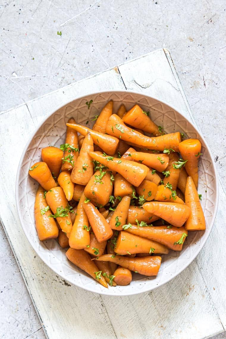 close up view of a ceramic plate filled with instant pot carrots