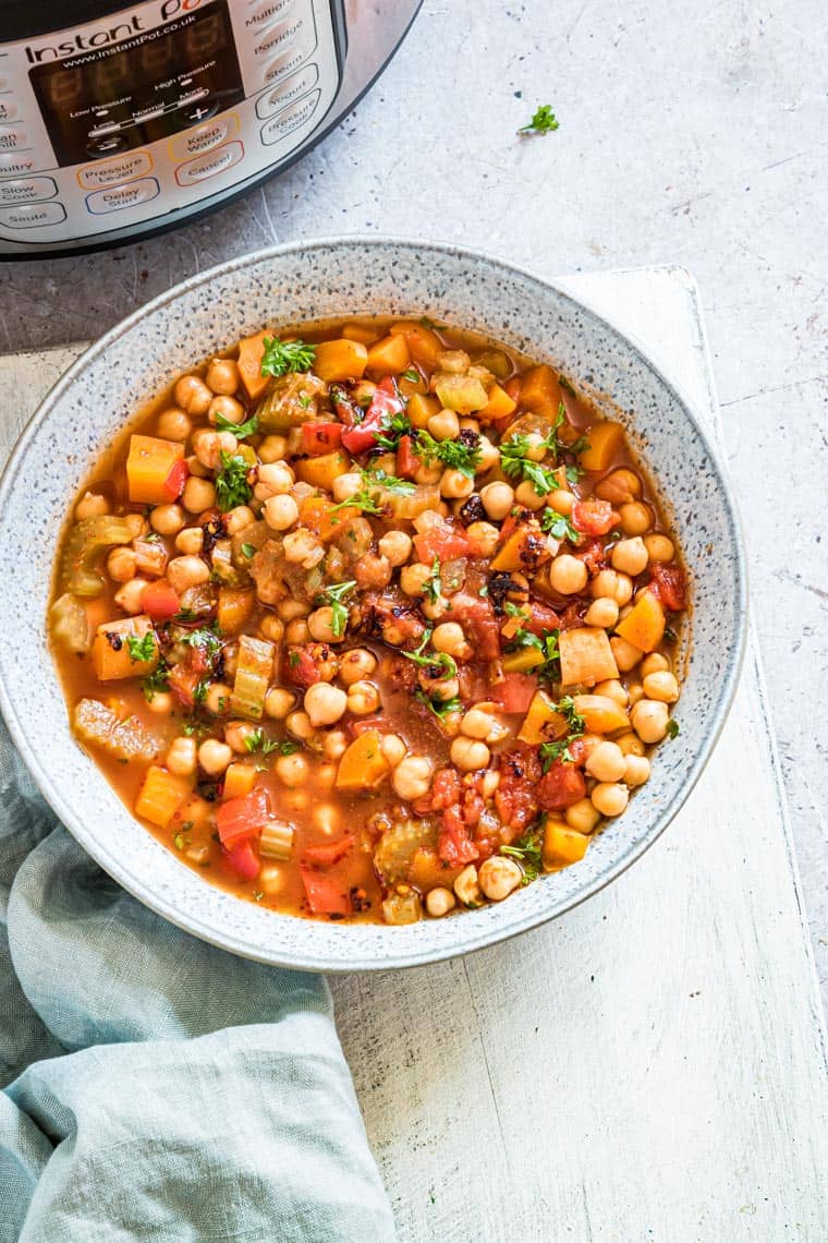 a bowl of Moroccan chickpea stew set in front of the instant pot