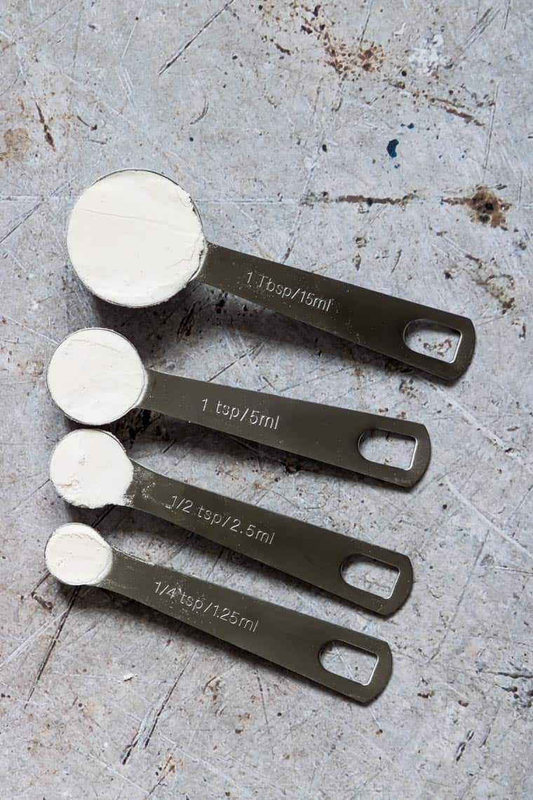 tablespoon and teaspoon measuring spoons filled with flour