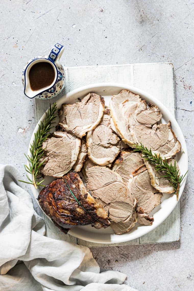 roast lamb recipe on a plate with garnish