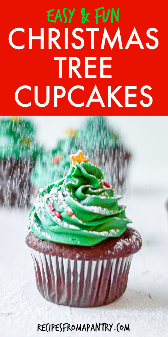 A christmas tree cupcake being sprinkled with powdered sugar