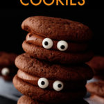a vertical stack of 3 chocolate cookies with candy eyes
