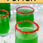 several glasses of green grinch punch with red sugar around the rim