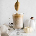 a glass of Pumpkin Spiced Whipped Coffee – Dalgona Coffee with a teaspoon