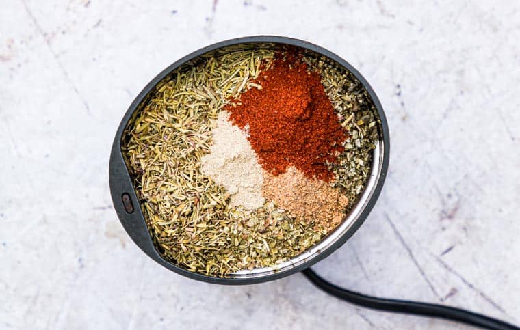 Ingredients to make poultry seasoning in a spice grinder