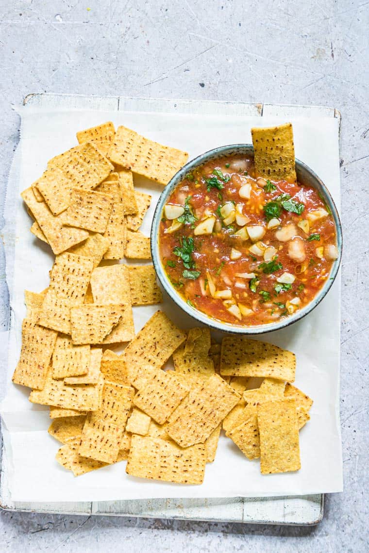 a bowl of tomato choka served with crispy tortilla chips