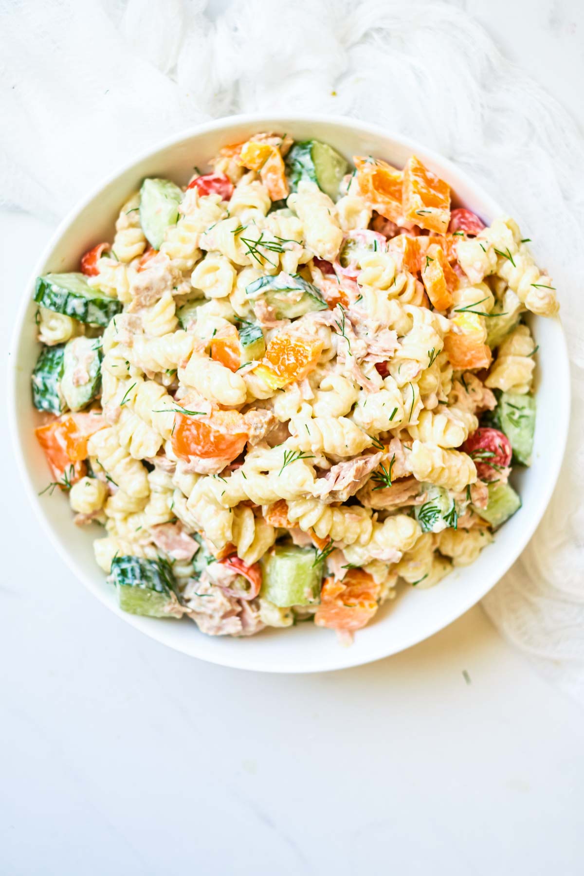 close up of creamy tuna pasta salad with vegetables