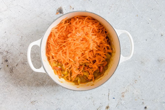 overhead shot of chakalaka recipe being prepared with shredded carrots on top