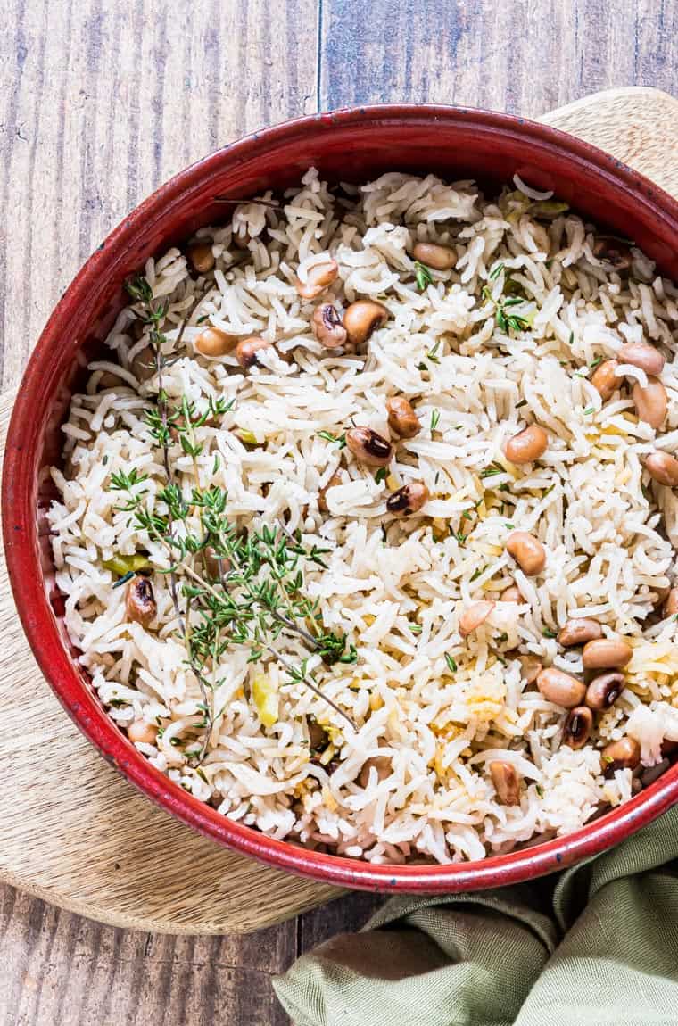 close up of jamaican rice and peas served in a red bowl