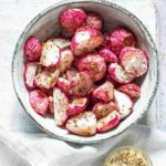 air fryer fried radishes in a bowl and served with a cup of dipping sauce