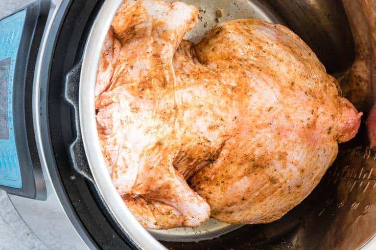 overhead view of instant pot whole chicken in instant pot ready to be cooked