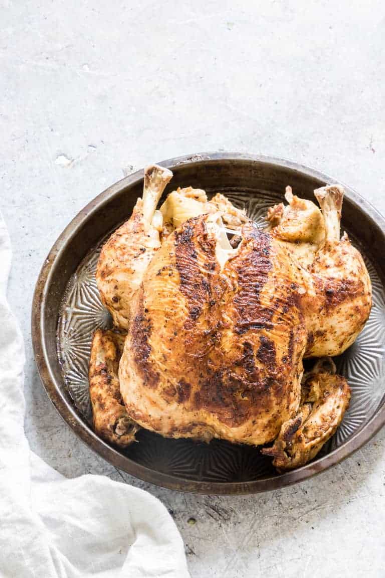 overhead view of instant pot whole chicken on a black platter