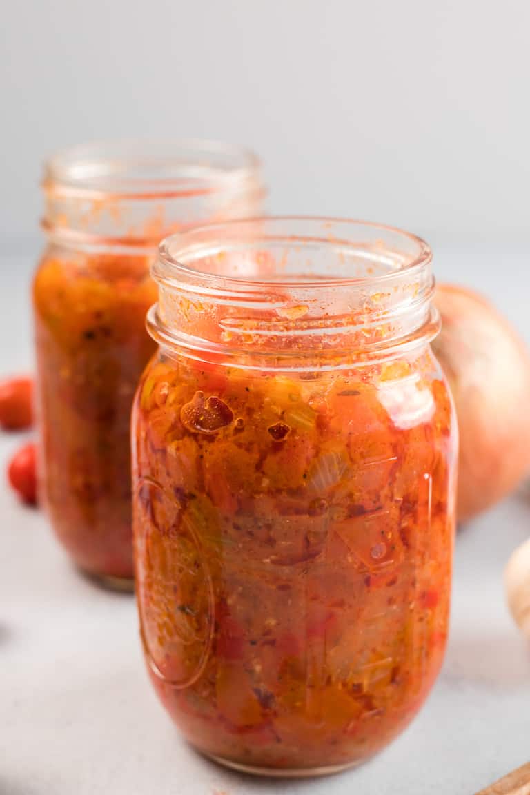 two glass storage jars filled with creole sauce