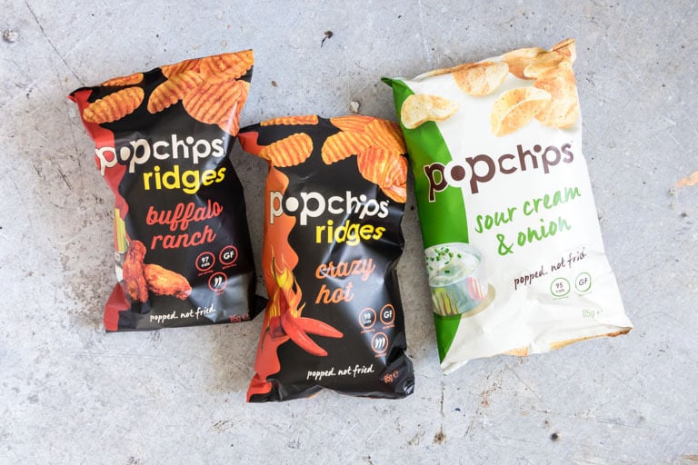three bags of popchips on a counter before being used in a rainbow sandwich