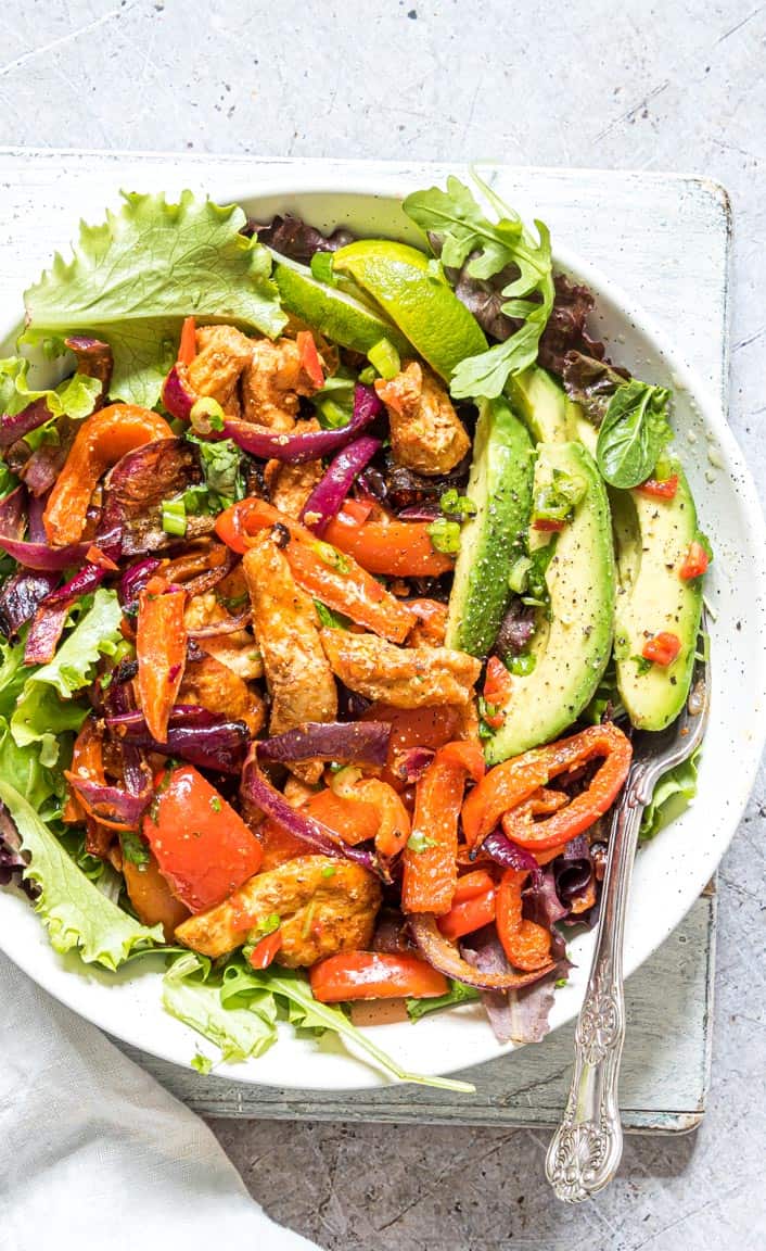 close up of a plate filled with chicken fajita salad