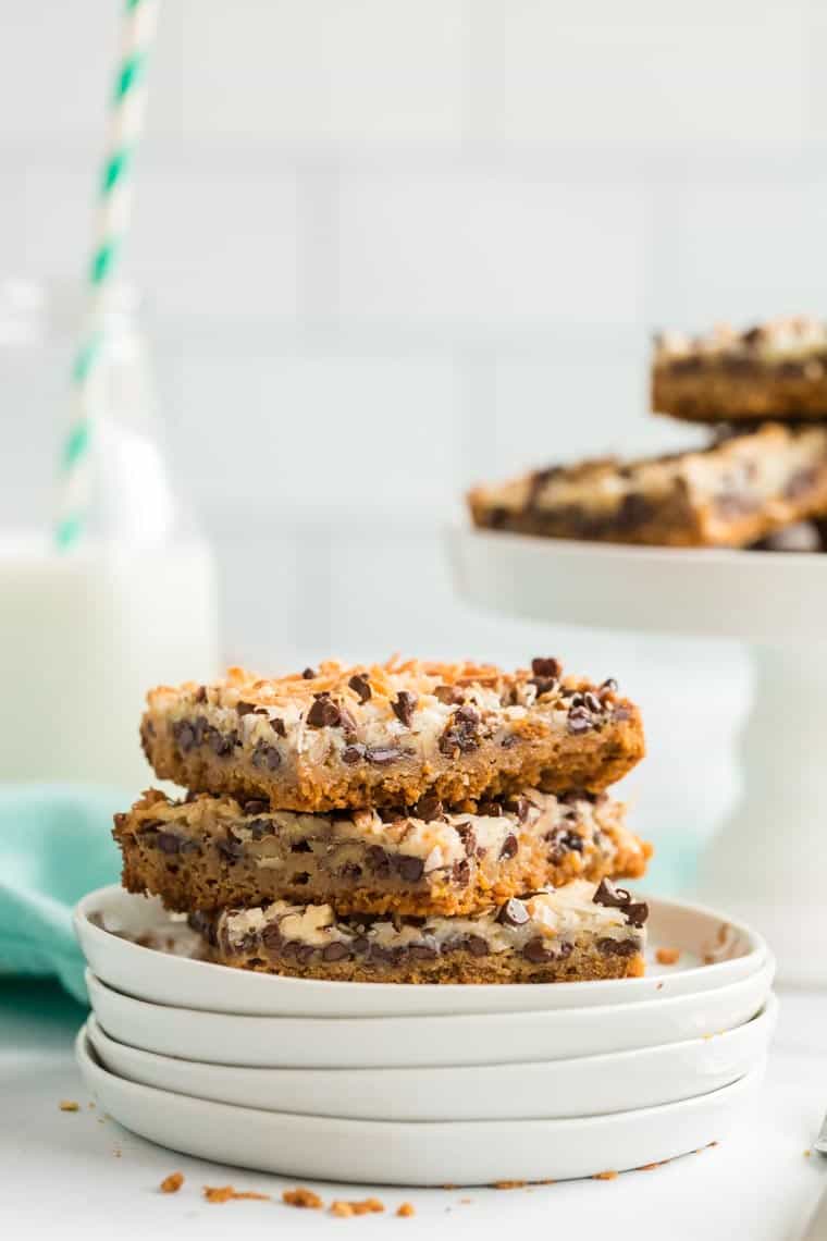 A stack of magic cookie bars on a plate