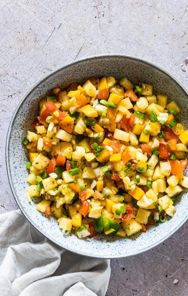 close up view of as bowl filled with mango pineapple salsa
