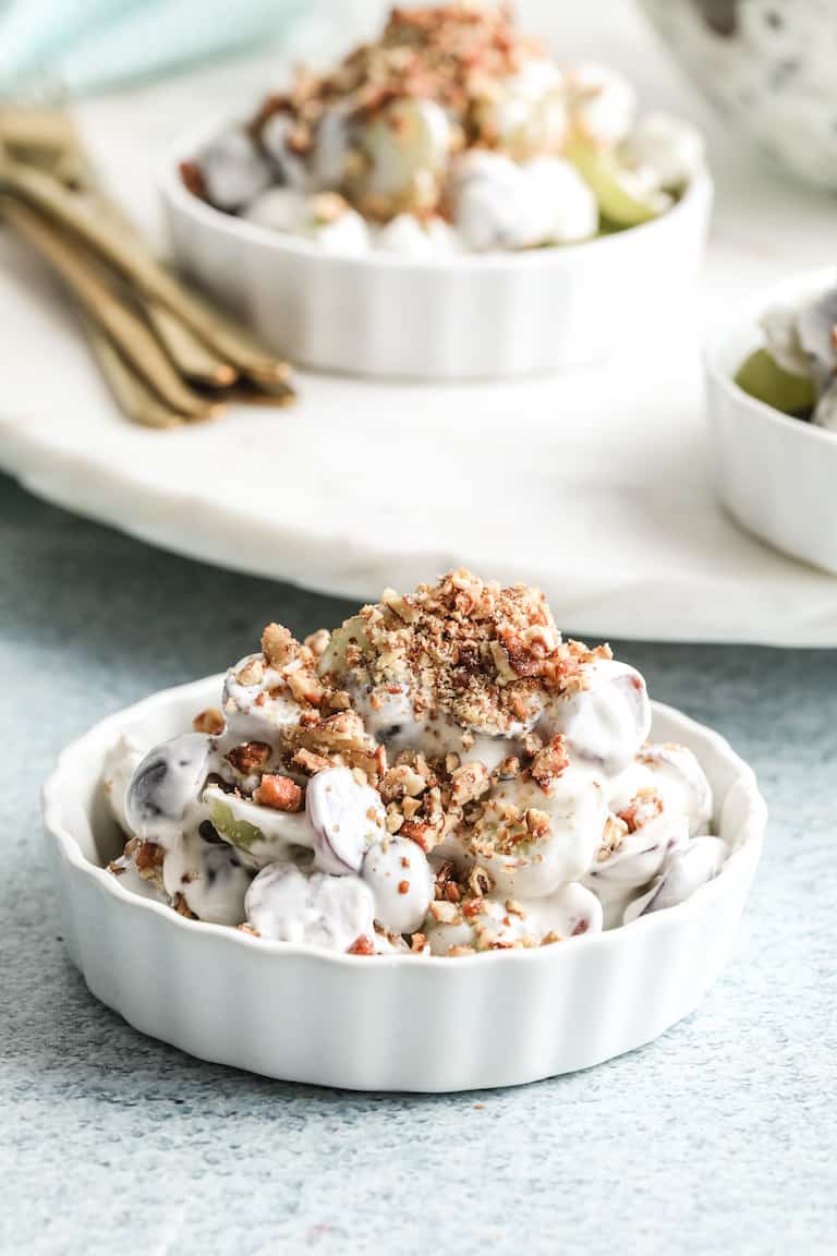a serving of southern grape salad in a white ceramic dish