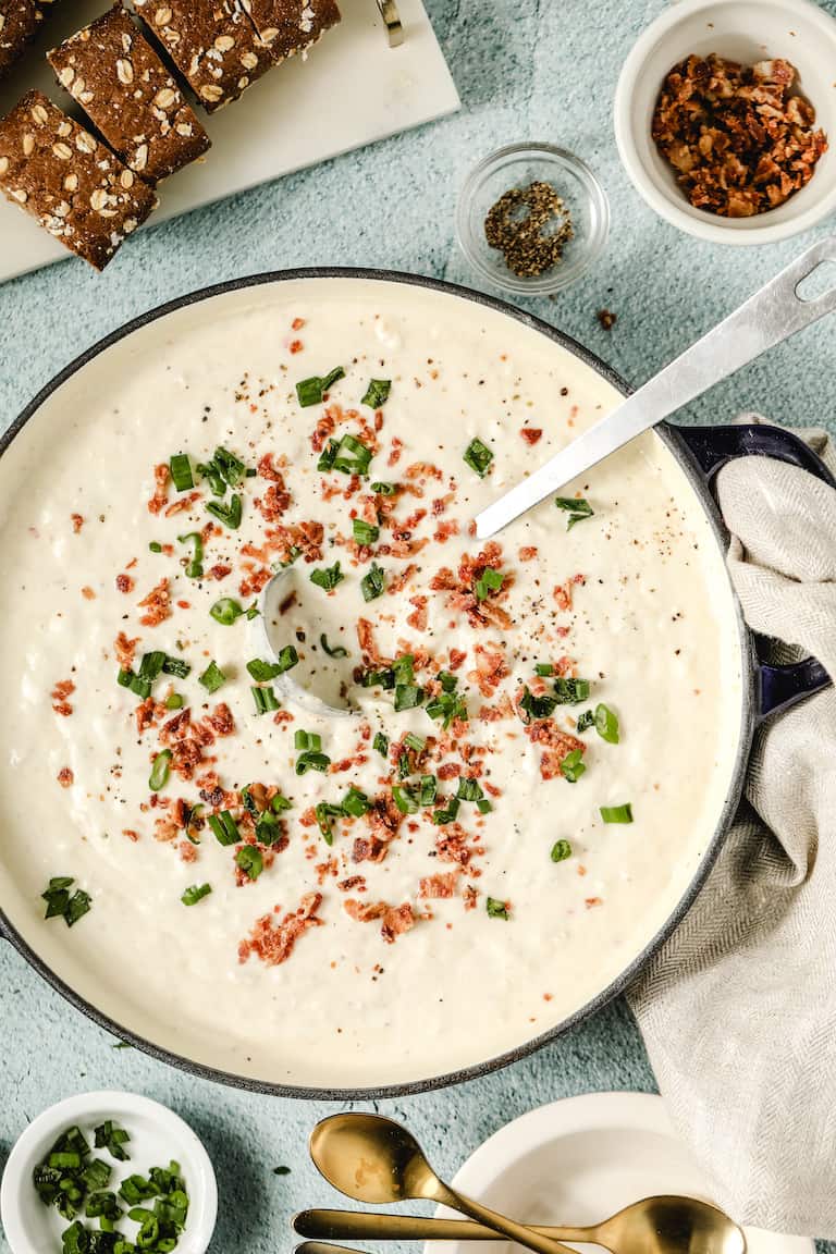 top down view of a bowl filled with Instant Pot Clam Chowder with a spoon inside