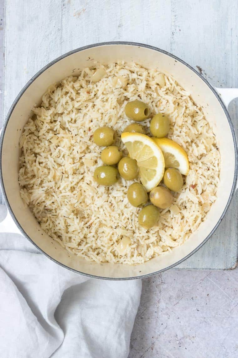 greek rice with olives and a slice of lemon