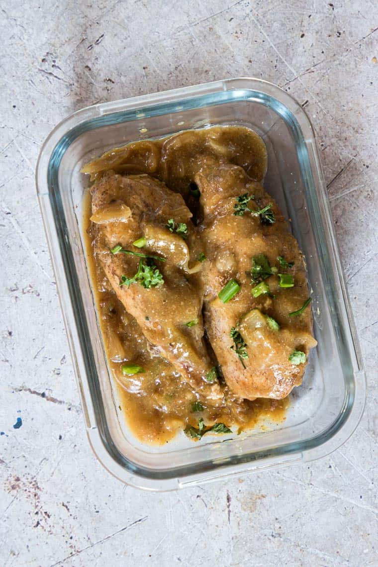 a glass meal prep container filled with smothered chicken