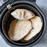 cooked flatbread inside the air fryer basket