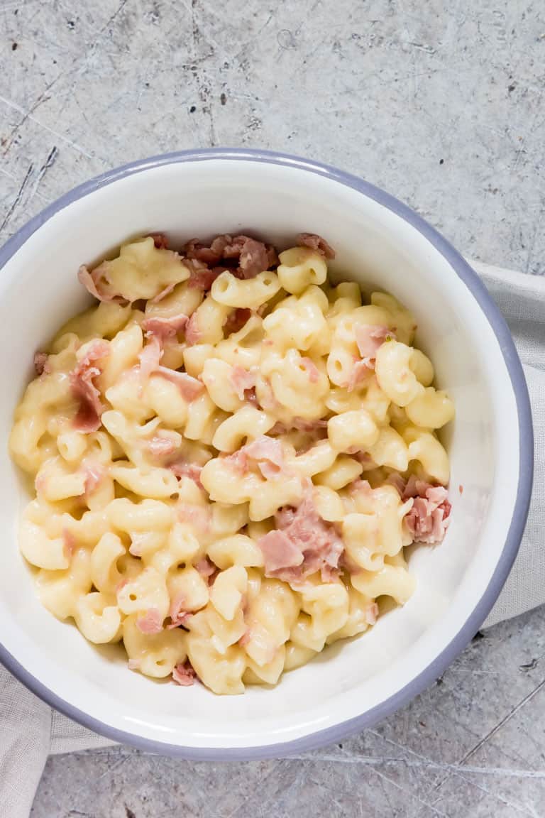 white bowl with blue rim containing ham instant pot mac and cheese